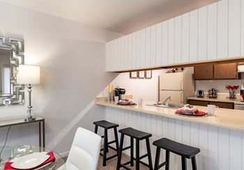 A kitchen and dining area in a 555 waverly unit